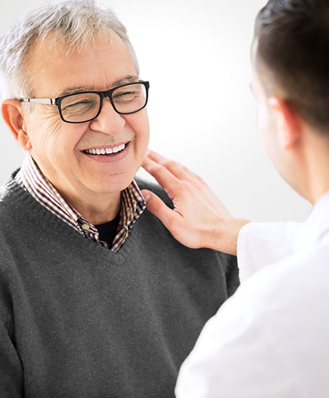Doctor talking and comforting a mature male patient who is smiling | Diabetes & Thyroid | Internal Medicine Prime Care