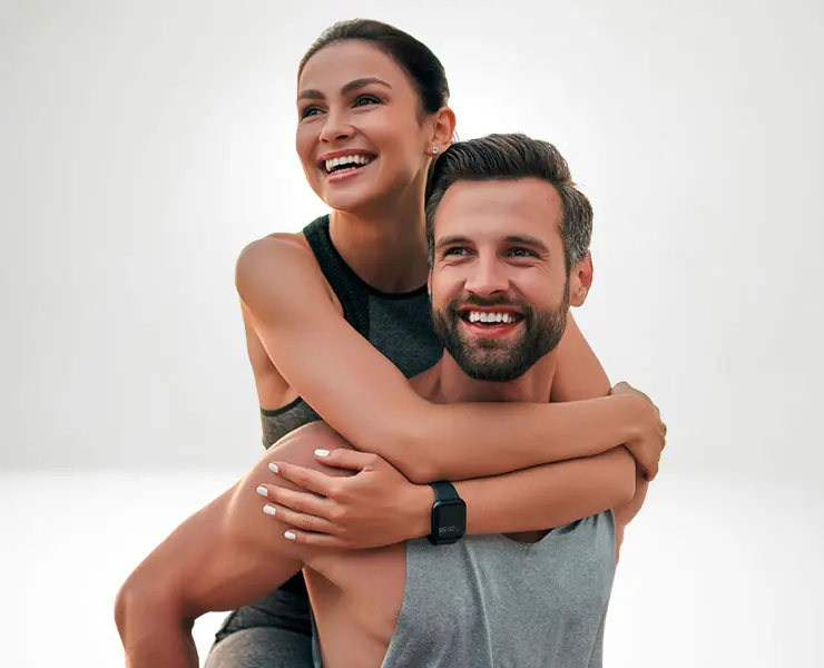 Young and happy couple holding each other after a workout | EMSCULPT NEO | Internal Medicine Prime Care